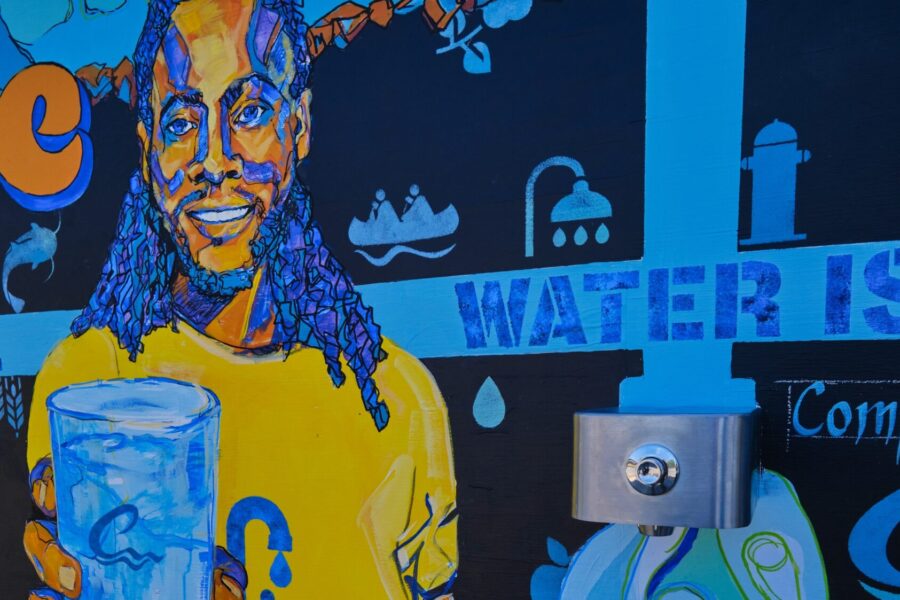 Mural of man with water and water tap in mural