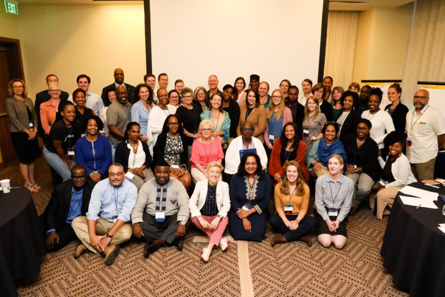 Group of people sitting and standing at conference