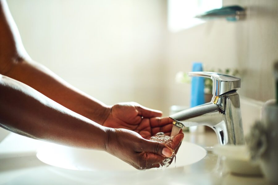 Hand washing in silver sink