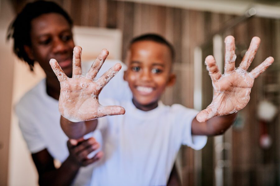 Boy with soapy hands smiling