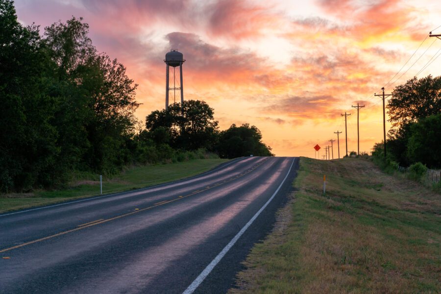 Rural road sunset water tower