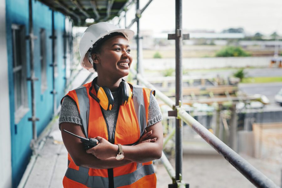 Woman arms crossed smiling construction site