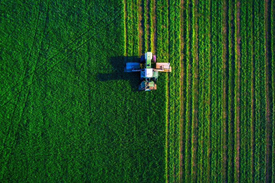 Tractor mowing green field