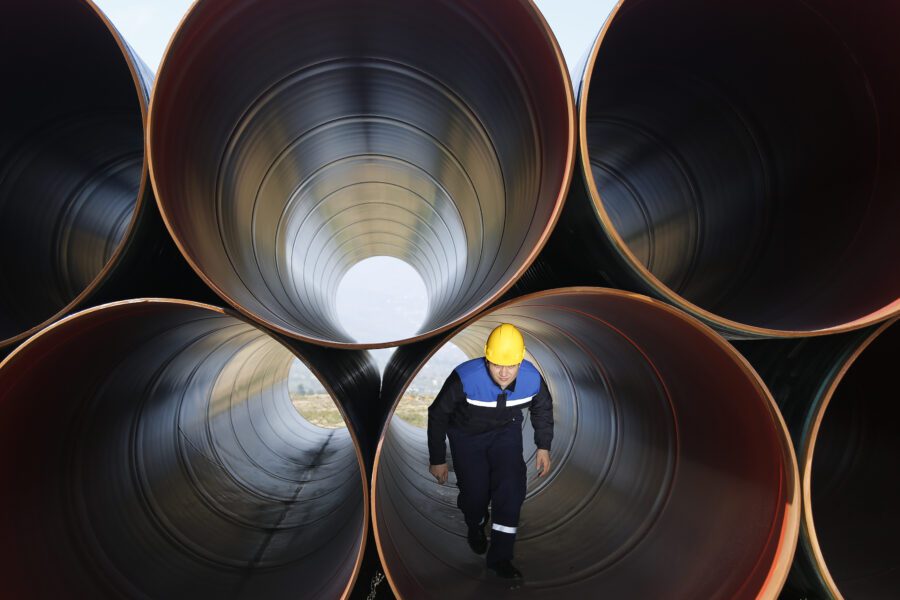 Man walking in large pipes