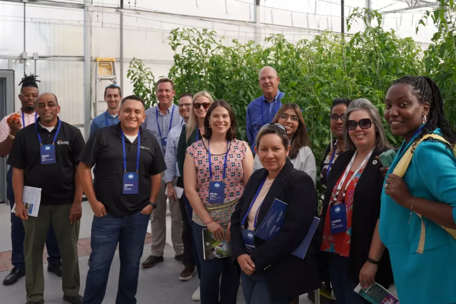 Group photo inside of greenhouse conference
