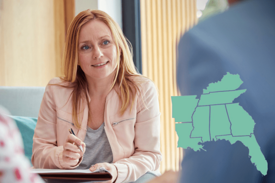 Woman in office listening to someone with US south map overlaid