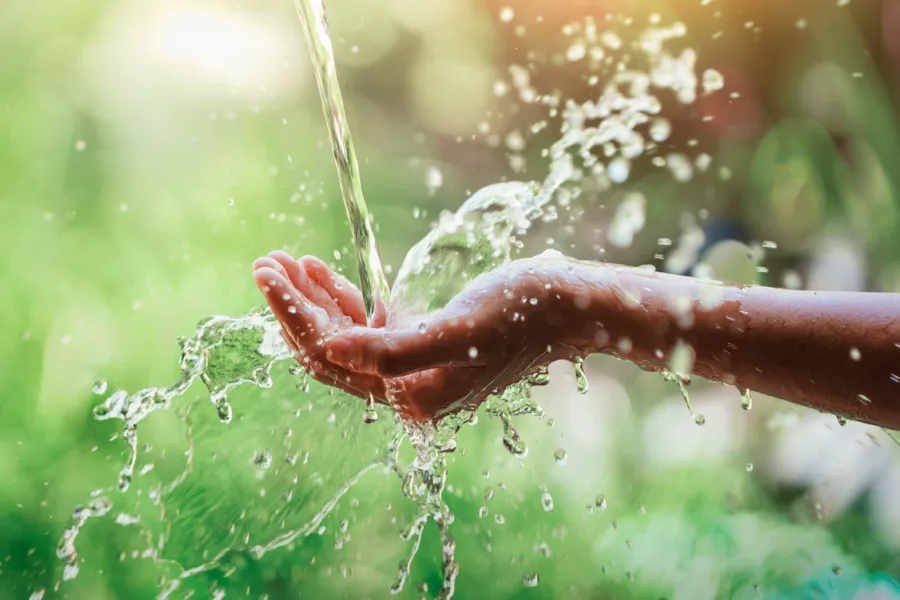 Hand with water splashing off of it close up