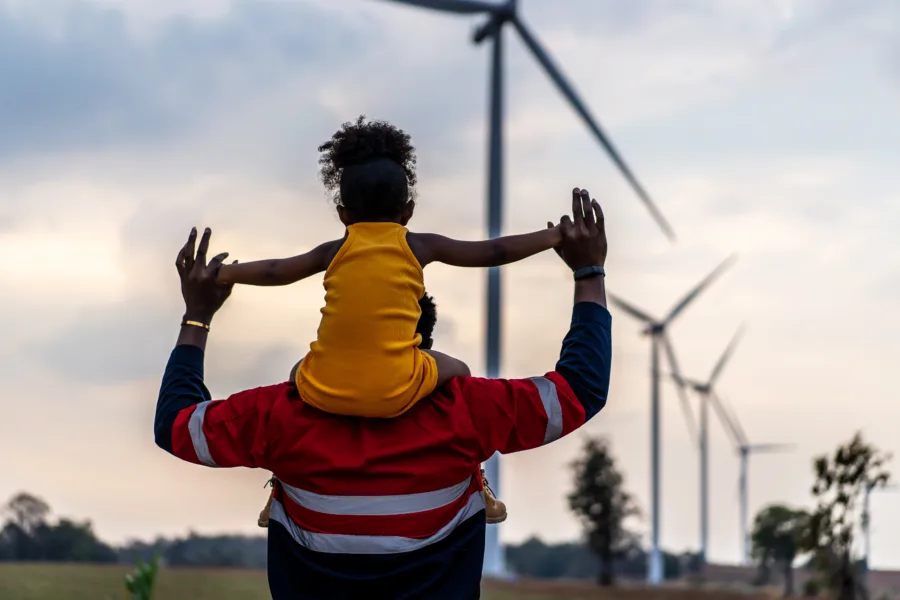 Dad with daughter and wind turbines