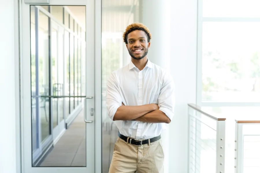 Man smiling in office building
