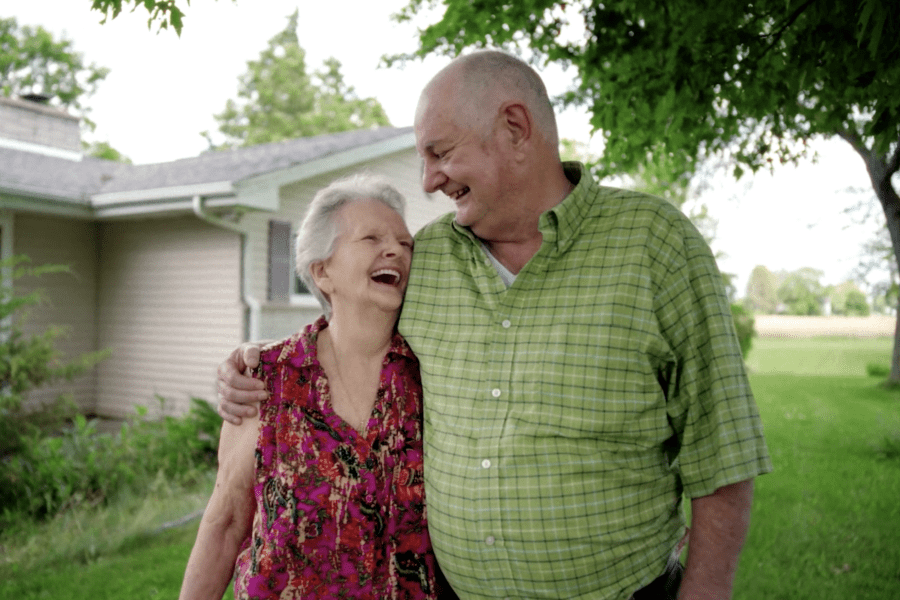 Couple smiling outside