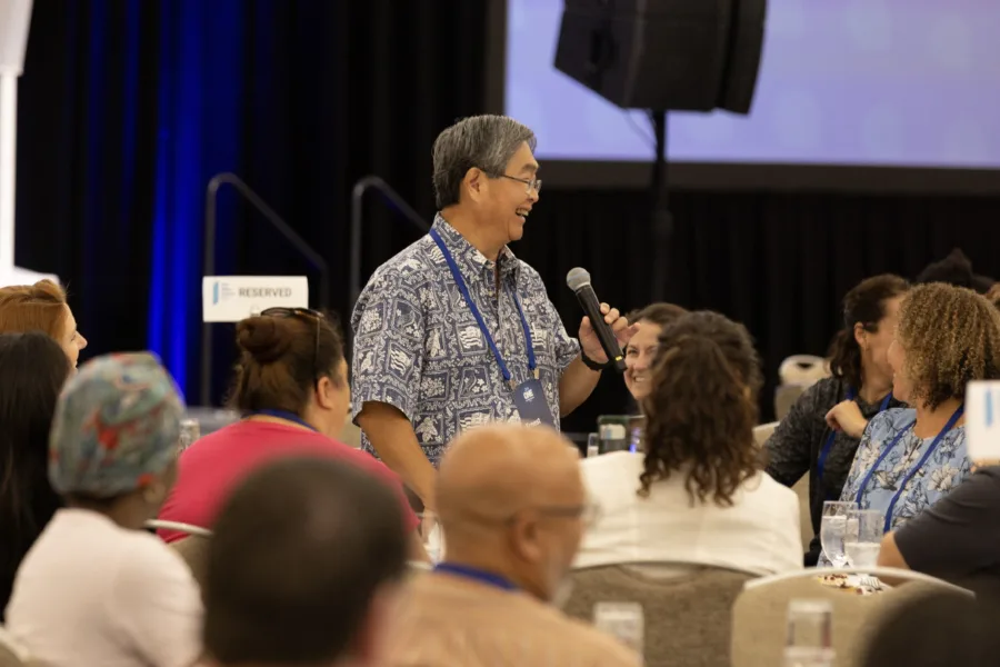 Man talking in microphone at conference